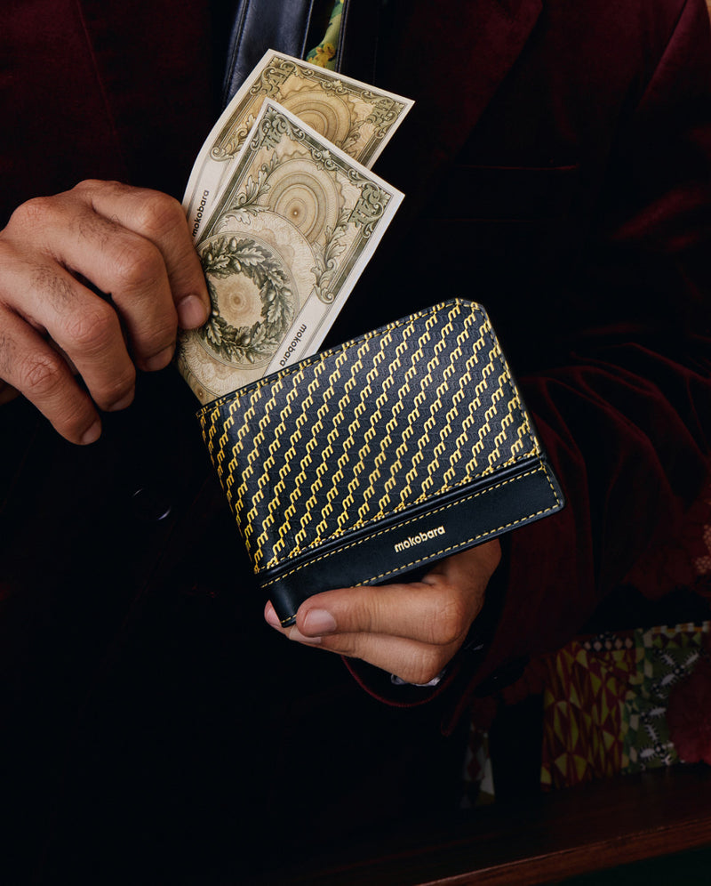 Cash tucked into a black Stash Bifold Wallet