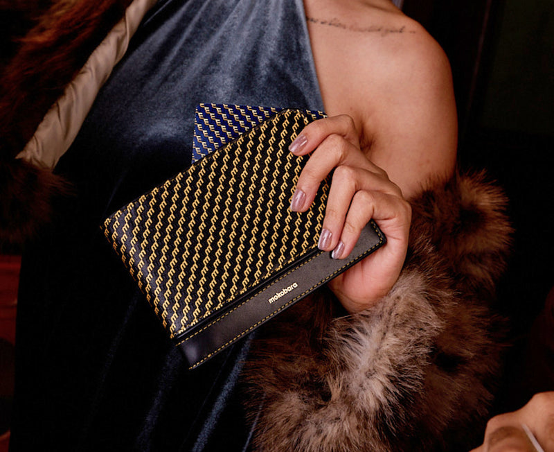 Stash Travel Wallet held against a fur coat